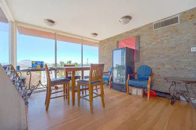a dining room with a table and chairs and a brick wall at Mojave Hotel in Mojave