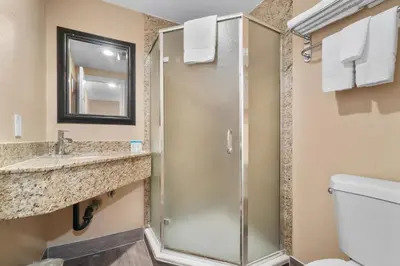a bathroom with a shower and a sink and a toilet at Santa Fe Inn Los Angeles in Huntington Park
