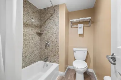 a bathroom with a toilet and a bath tub at Santa Fe Inn Los Angeles in Huntington Park