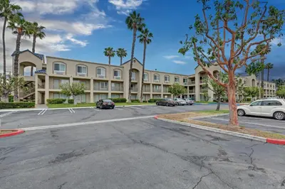 a parking lot in front of a large building at Good Nite Inn Buena Park in Buena Park
