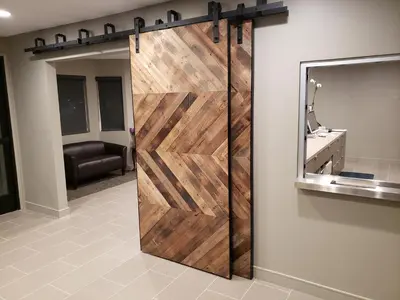 a sliding barn door in a bathroom with a mirror at Good Nite Inn Calabasas in Calabasas