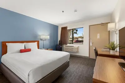 a hotel room with a large bed and a window at Good Nite Inn Camarillo in Camarillo