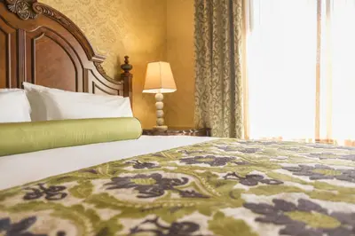 a bedroom with a bed with a bedspread with flowers on it at Ayres Hotel Manhattan Beach in Hawthorne