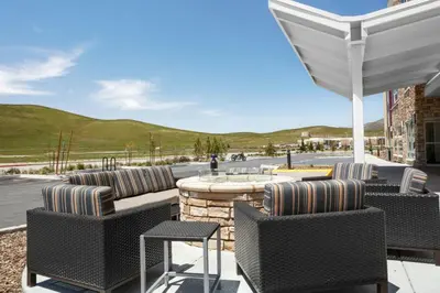 a patio with chairs and a table with a view at TownePlace Suites By Marriott Tehachapi in Tehachapi