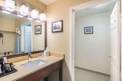 a bathroom with a sink and a mirror at Comfort Inn & Suites Mojave in Mojave