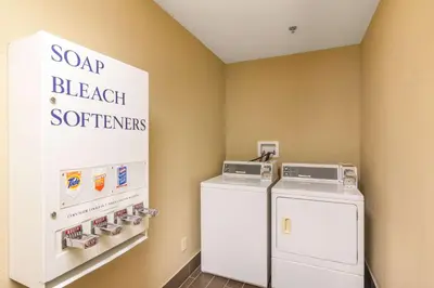 a laundry room with a refrigerator and a sign at Comfort Inn & Suites Mojave in Mojave