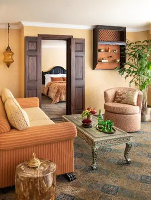 a living room with a couch and a table at Petit Ermitage in Los Angeles