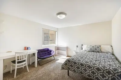 a bedroom with a bed and a desk and a desk at Seaside Getaway in Oxnard