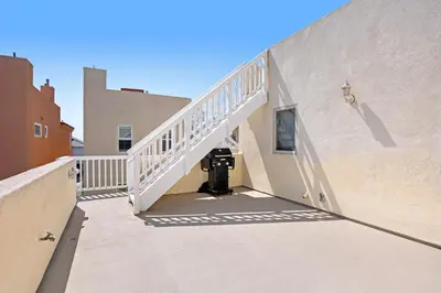 a stairway leading to a building with a stair case at Seaside Getaway in Oxnard