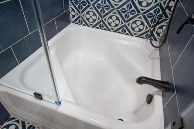 a white bath tub in a bathroom with blue tiles at Dreamy Farmhouse in Studio City in Los Angeles