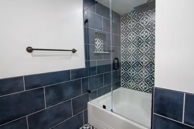 a bathroom with blue tiles and a tub at Dreamy Farmhouse in Studio City in Los Angeles