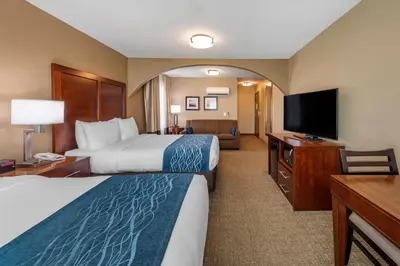 a hotel room with two beds and a flat screen tv at Comfort Inn & Suites Ventura Beach in Ventura