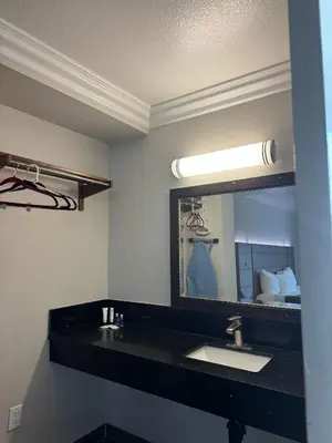 a bathroom with a sink and a mirror at Rodeway Inn Ventura Midtown in Ventura