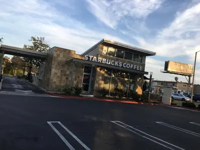 a starbucks coffee building on the side of a street at OceanView Motel in Huntington Beach