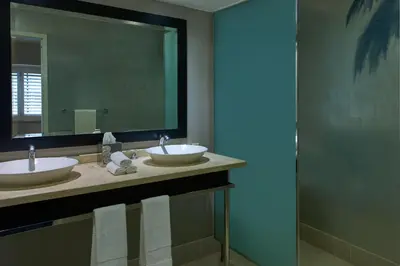 a bathroom with two sinks and a large mirror at W Los Angeles – West Beverly Hills in Los Angeles