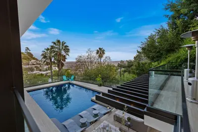 a swimming pool with a view of a house at Franklin Modern in Los Angeles