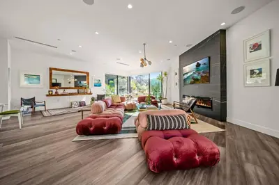 a living room with red couches and a fireplace at Willow Glen in Los Angeles