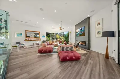 a living room with red couches and a fireplace at Willow Glen in Los Angeles