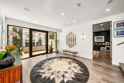 a living room with a large rug on the floor at Willow Glen in Los Angeles