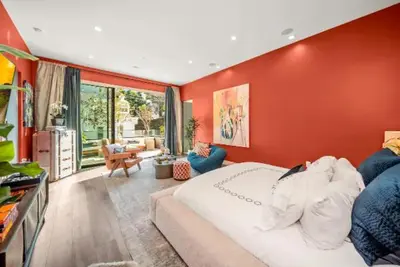 a bedroom with red walls and a large bed at Willow Glen in Los Angeles