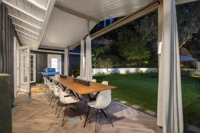a patio with a wooden table and chairs at Hidden Valley PL in Los Angeles