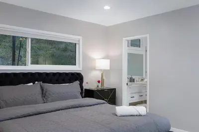 a white bedroom with a bed and a window at Hidden Valley PL in Los Angeles