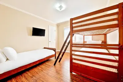 a bedroom with a bunk bed and a ladder to a bunk bed at Disney Getaway in Anaheim