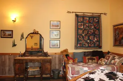 a room with a mirror and a couch and a table at The Old Bear BnB in Pine Mountain Club