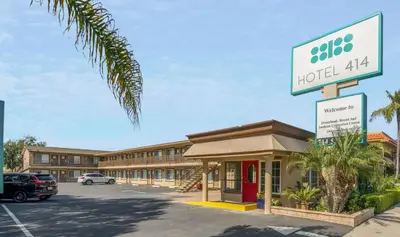 a hotel atlas sign in front of a parking lot at Hotel 414 Anaheim in Anaheim