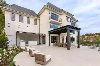 a large white house with a patio at Beverly Hills Maison in Beverly Hills
