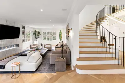 a living room with a staircase and a couch at Beverly Hills Maison in Beverly Hills