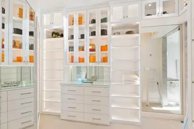 a white walk in closet with white cabinets at Beverly Hills Maison in Beverly Hills