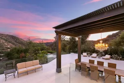 an outdoor patio with a view of the mountains at Beverly Hills Maison in Beverly Hills