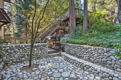 a stone retaining wall with a staircase and a wooden deck at Tranquil Twin Peaks Retreat Hike, Ski and Swim in Twin Peaks
