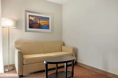 a living room with a couch and a table at Best Western Royal Palace Inn & Suites in Los Angeles