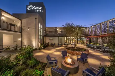 a courtyard with chairs and a fire pit in a building at Olivia Hotel in Los Angeles