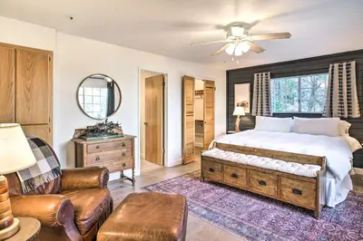 a bedroom with a bed and a couch and a chair at Luxe Lake Arrowhead Getaway with Treetop Views! in Lake Arrowhead