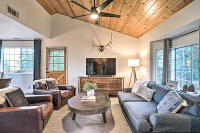 a living room with couches and a tv at Luxe Lake Arrowhead Getaway with Treetop Views! in Lake Arrowhead