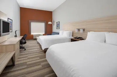 a hotel room with two beds and a flat screen tv at Holiday Inn Express Ontario by IHG in Creekside