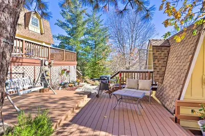 a deck with a bench and a grill on a house at Lake Arrowhead Studio Near Hiking with Hot Tub in Lake Arrowhead