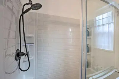 a shower with a glass door in a bathroom at Modern Cabin with Game Room and Deck, Near Skiing in Running Springs