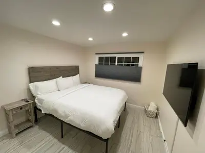 a bedroom with a white bed and a window at Cheerful, Beautifully Remodeled, Modern, Comfortable Home in Los Angeles