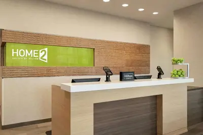 a lobby with a counter with two phones on it at Home2 Suites By Hilton Woodland Hills Los Angeles in Woodland Hills
