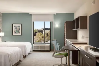 a hotel room with a bed and a desk and a kitchen at Home2 Suites By Hilton Woodland Hills Los Angeles in Woodland Hills