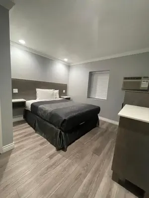 a bedroom with a large bed in a room at EL PATIO HOTEL in San Bernardino