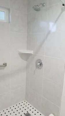 a bathroom with a shower with a glass door at Royale Inn Motel in Whittier