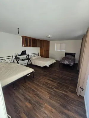 a room with two beds and a wooden floor at Los Angeles 3 Bedroom Charmer Large Guest House in Los Angeles