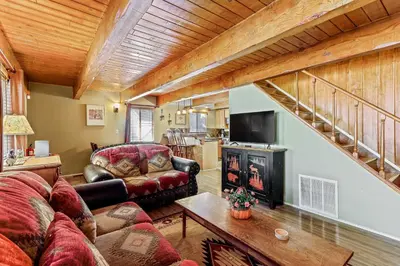 a living room with a couch and a fireplace at Adorable Explorable in Lake Arrowhead