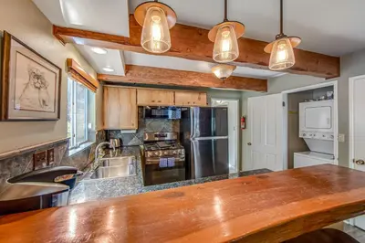 a kitchen with a large wooden counter top at Adorable Explorable in Lake Arrowhead