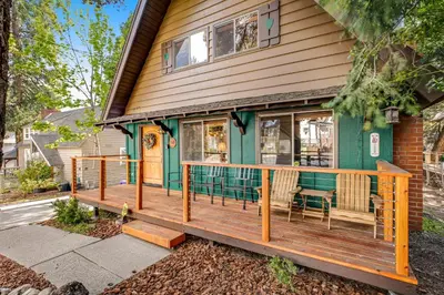 a front porch of a house with a wooden deck at Adorable Explorable in Lake Arrowhead